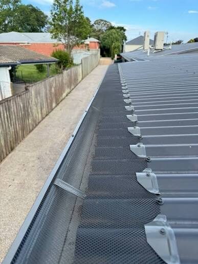 Close-up of gutter guard mesh fitted and clipped along a Sydney gutter