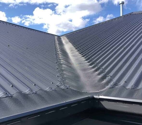 Aluminium gutter guard mesh installed along a Sydney metal roofline