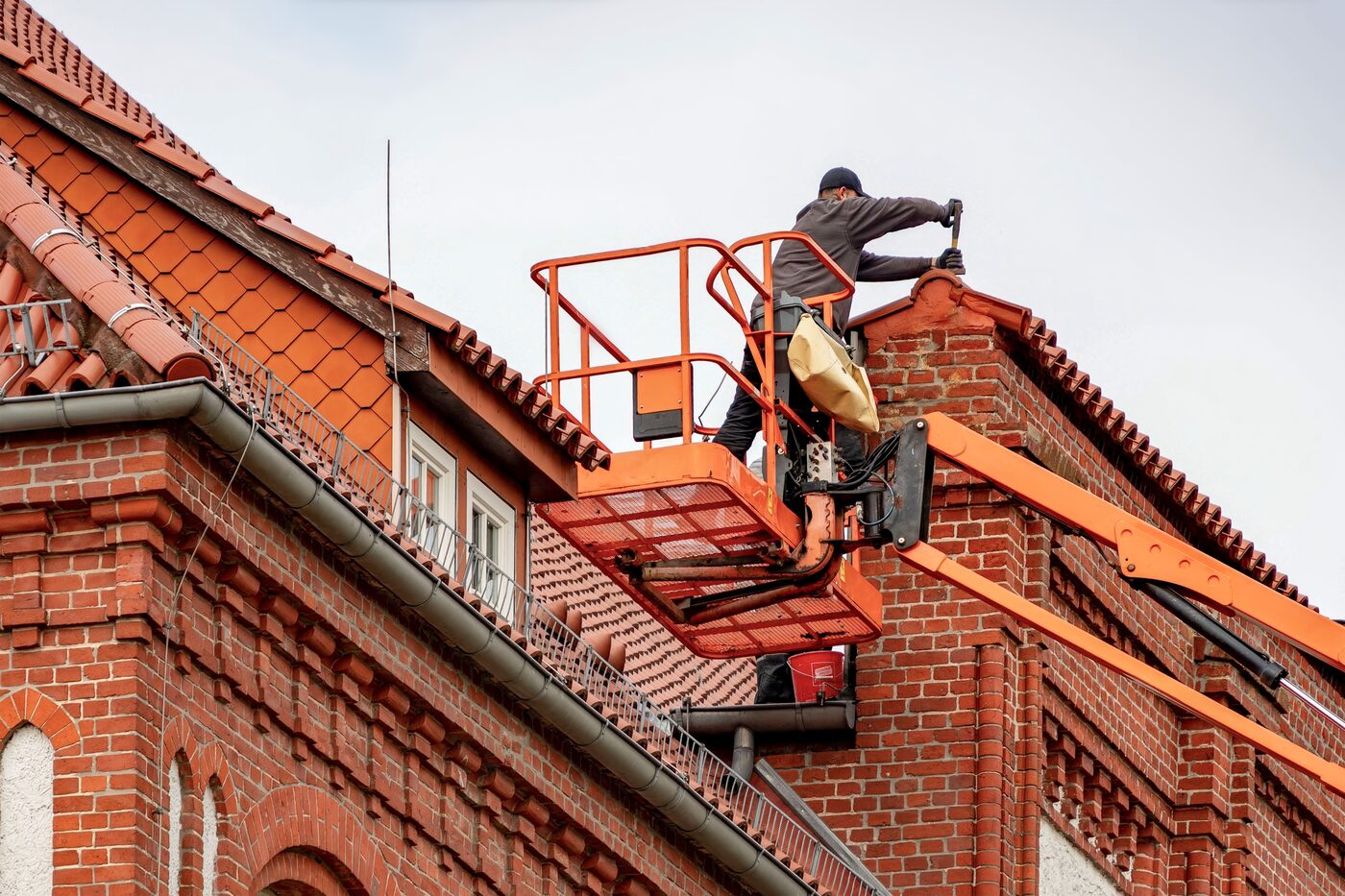 Sam on an elevated work platform accessing a Sydney roofline for gutter and roof cleaning