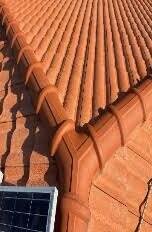Close-up of a cleaned terracotta tile ridge line after pressure washing